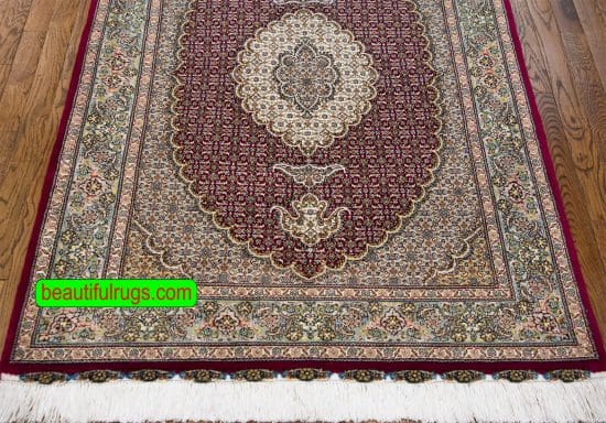 Traditional Persian Tabriz rug in raspberry red color made of wool and silk. Size 3.4x5.