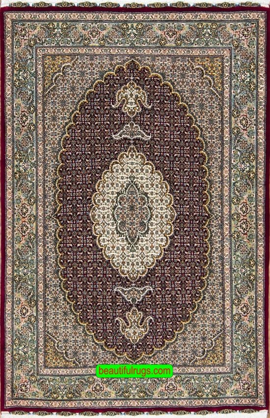 Traditional Persian Tabriz rug in raspberry red color made of wool and silk. Size 3.4x5.