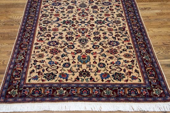 Handmade Persian Sarouk area rug with beige color in the main field and red in the borders. Size 4.2x6.8.