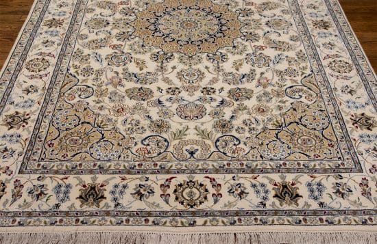 Hand knotted wool area rug floral design in beige color. Rug size 6.1x9.3.