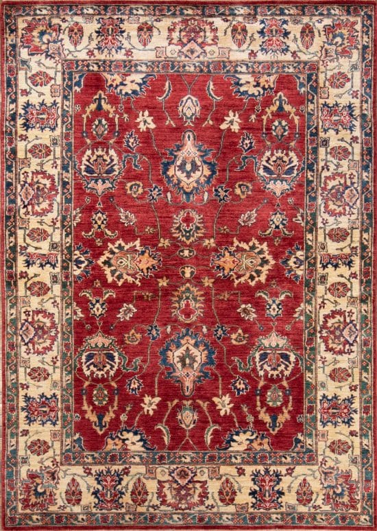 A floral-geometric handmade wool Kazak style rug in red and beige colors. Size 6x9.