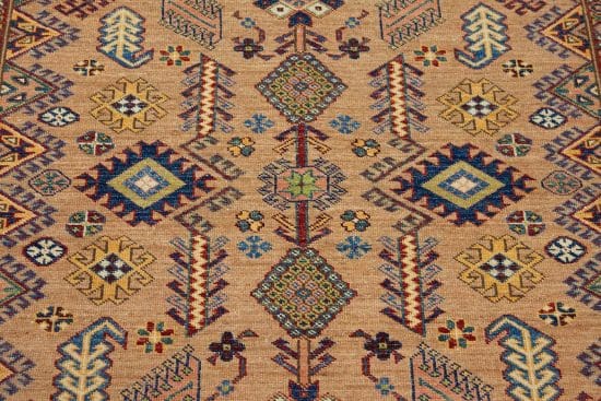 Handmade oriental rug in geometric Kazak style in brown and blue color. Size 5.1x7.