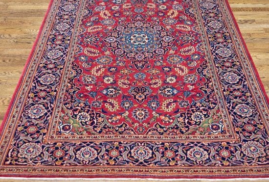 Hand knotted floral design vintage Persian Kashan rug in red color. Rug size 4.6x7.3.