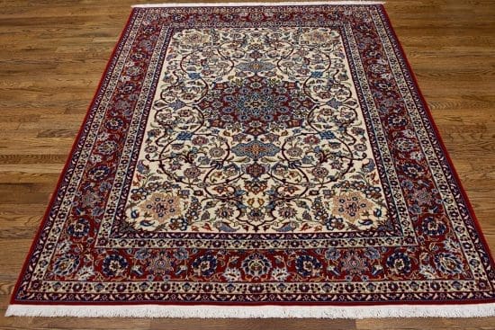 Authentic handmade antique Persian Isfahan Wool rug with beige and red colors. Rug size 5x7.