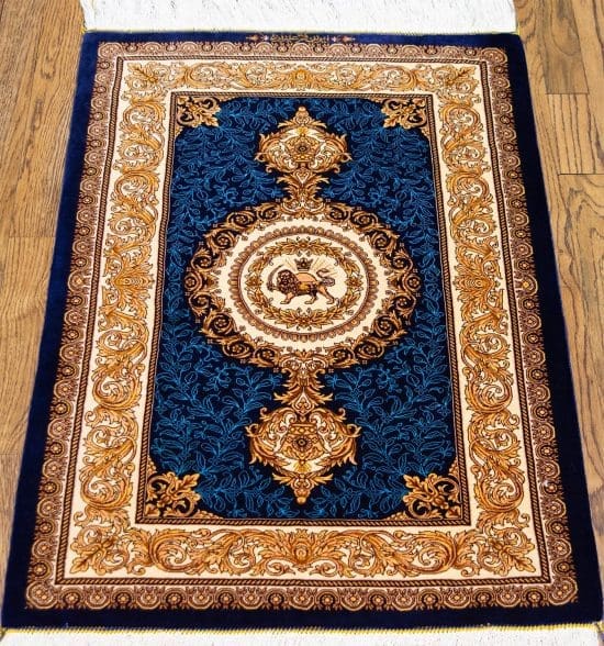 Hand knotted Persian Qum pure silk rug in royal blue and gold colors with lion and sun symbol.