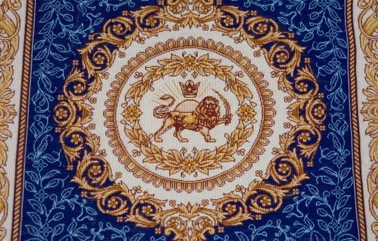 Hand knotted Persian Qum pure silk rug in royal blue and gold colors with lion and sun symbol.