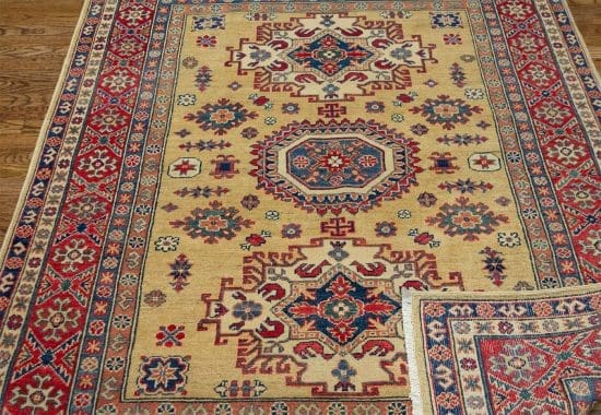 Handmade oriental rug Kazak style with Caucasian motifs in chartreuse color. Rug size 4.10x6.10.