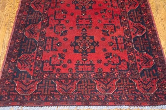 Handmade tribal area rug from Afghanistan with red and black colors. Rug size 3.6x5.1.